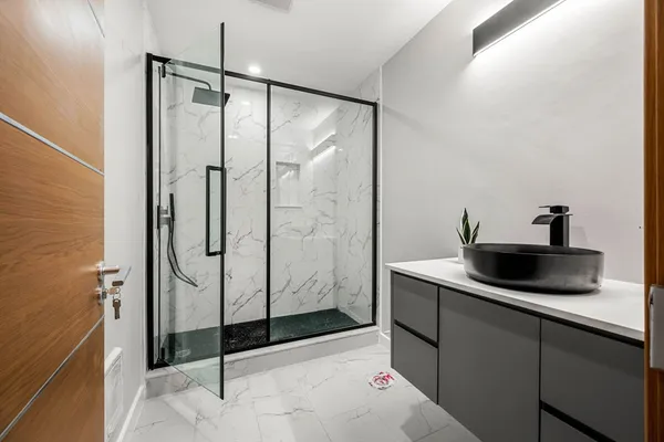 a bathroom with a shower and a sink