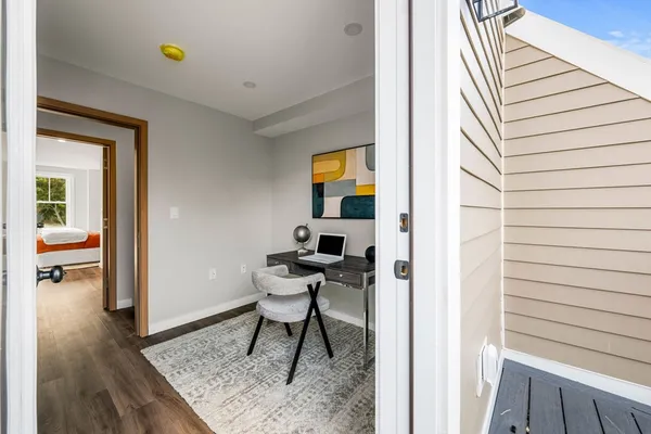 a view of living room with furniture and wooden floor