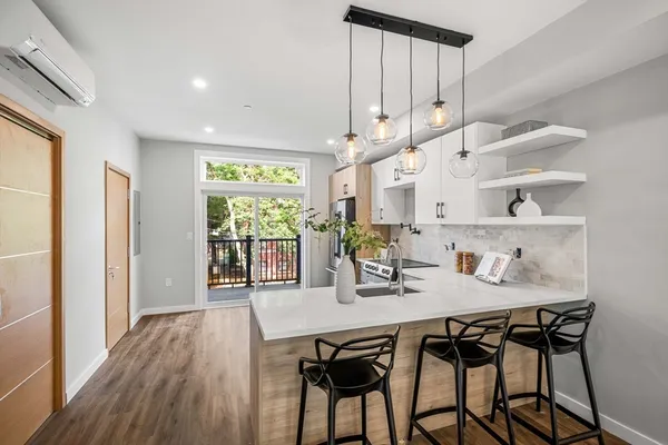 a dining room with furniture and wooden floor