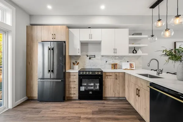 a kitchen with a refrigerator and a stove