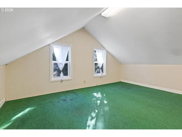 a view of an empty room with windows