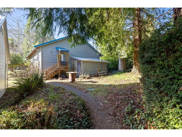 a view of a house with backyard and sitting area