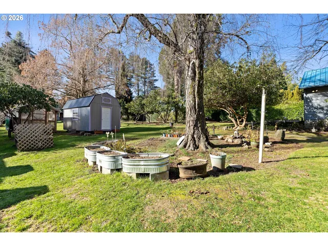 a backyard of a house with table and chairs