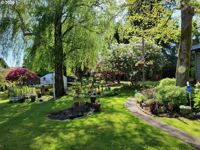 a garden with lots of trees and flowers