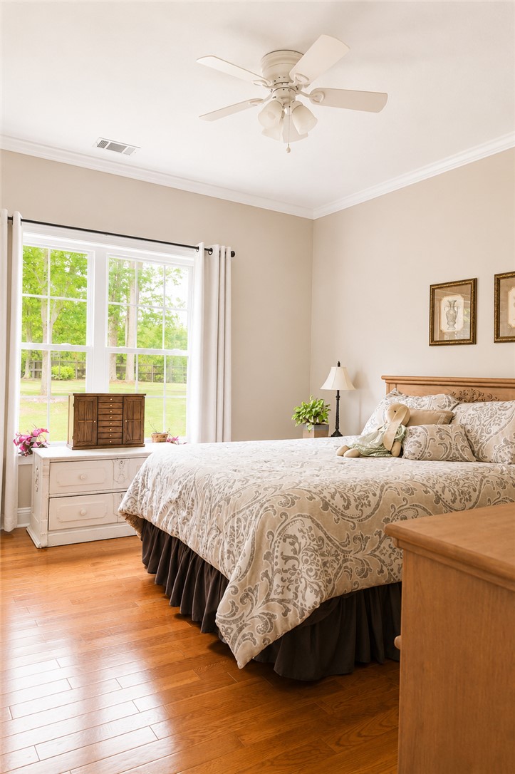190 Fred Bradford Road Iva, SC 29655 - Photo 19 of 32 This tranquil bedroom offers warmth and comfort, ideal for unwinding after a long day.