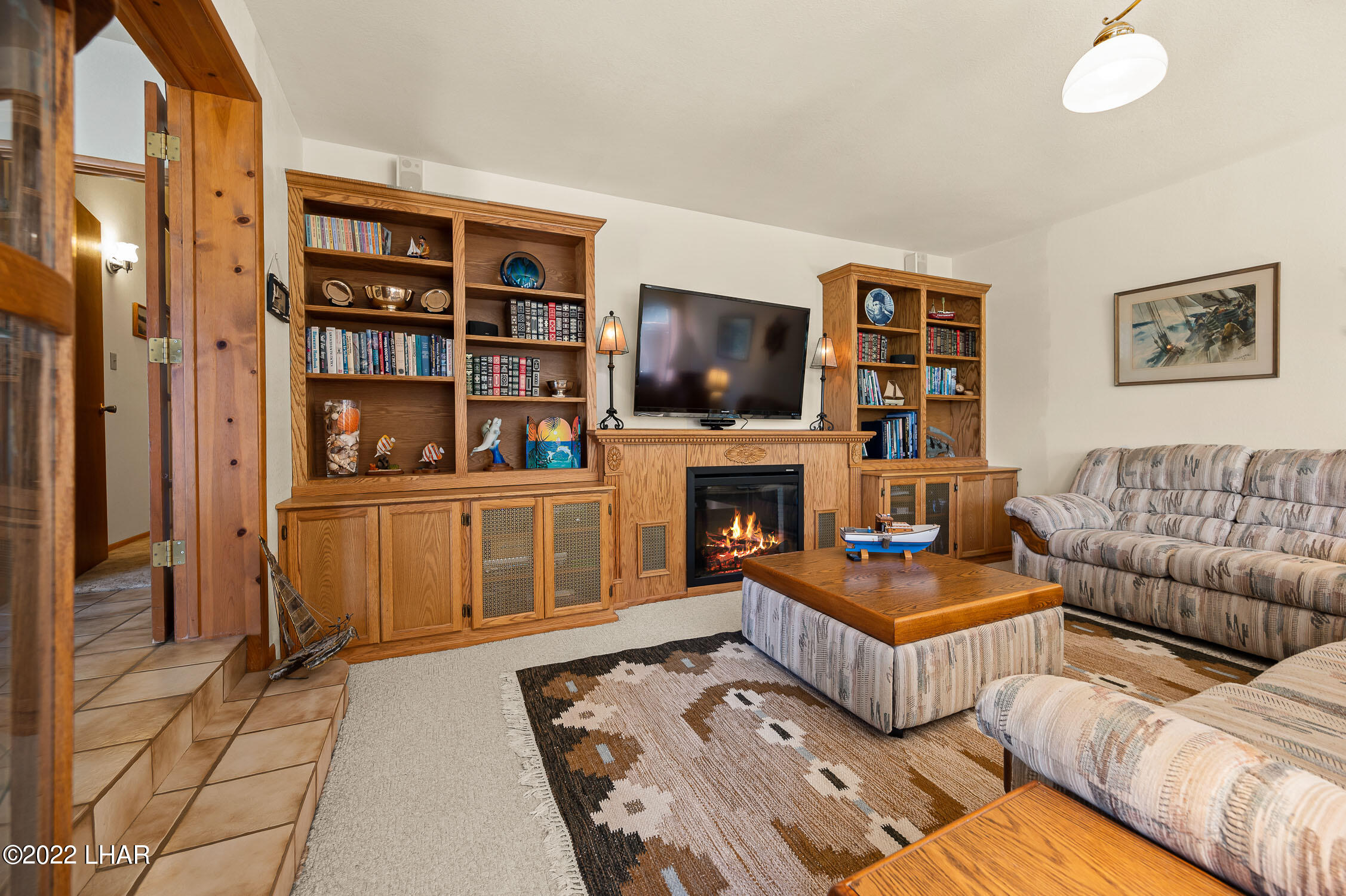6712 Flag Mine Road Kingman, AZ 86401 - Photo 41 of 72 Entertainment center lights with fireplace for that ambience.