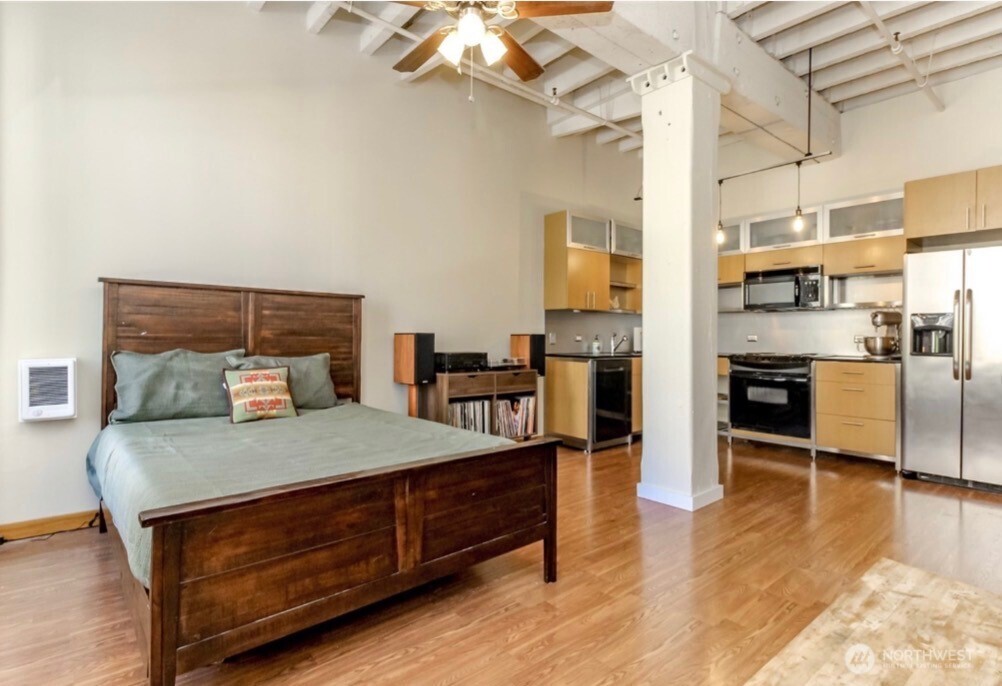 a bed room with a bed and a kitchen view