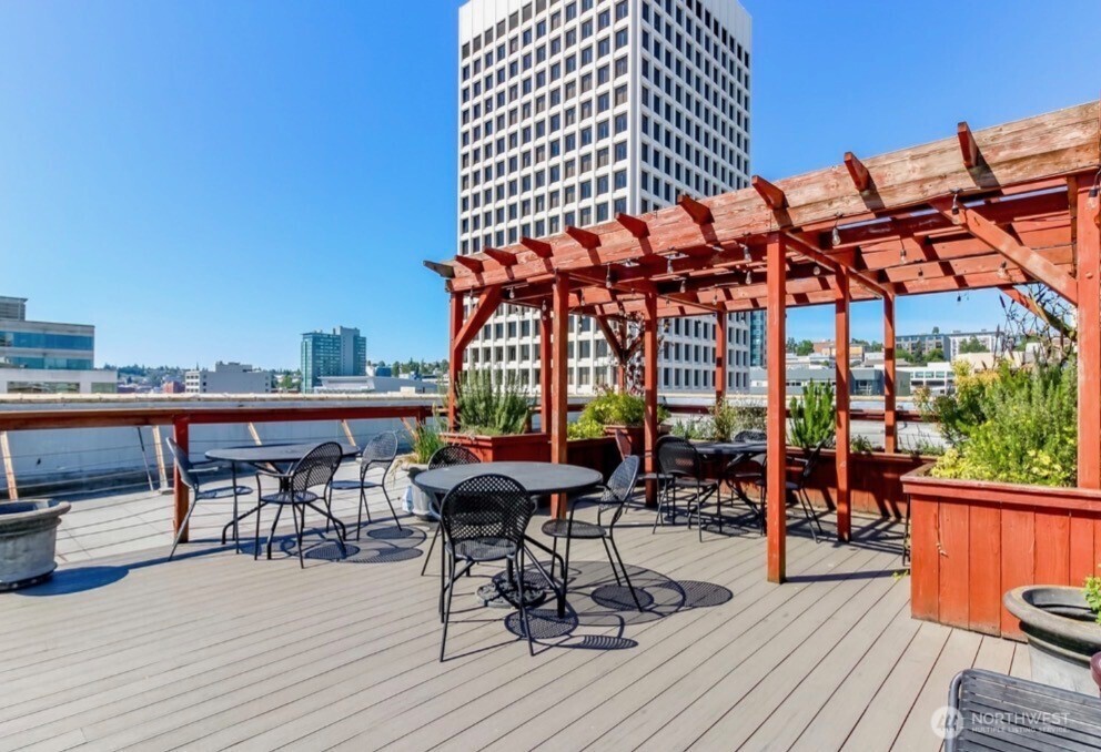 1120 Cliff Street, Unit 211 Tacoma, WA 98402 - Photo 13 of 20 a view of a roof deck with table and chairs