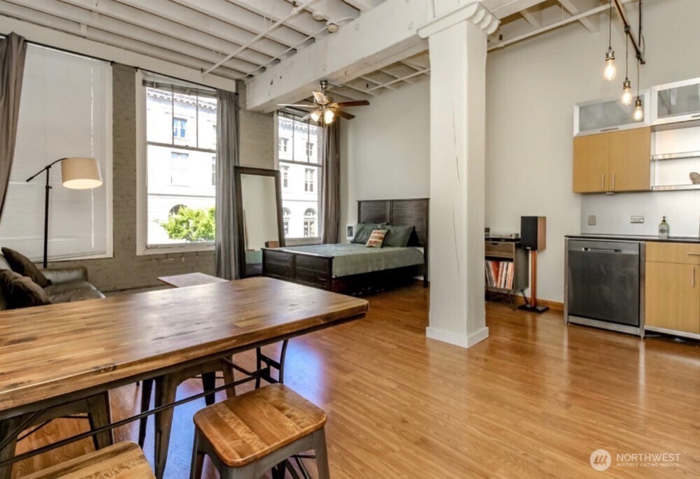 1120 Cliff Street, Unit 211 Tacoma, WA 98402 - Photo 2 of 20 a view of a dining room with furniture and wooden floor