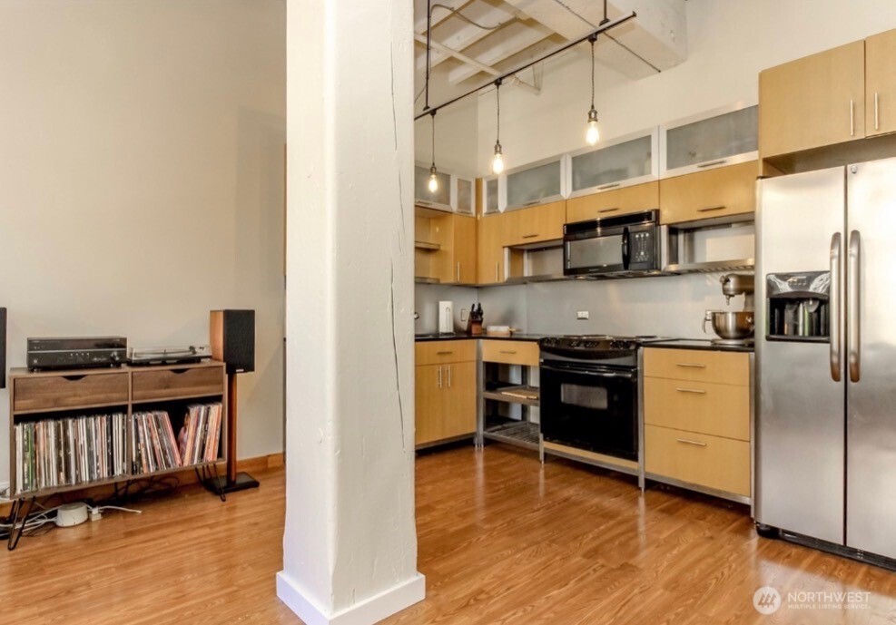 1120 Cliff Street, Unit 211 Tacoma, WA 98402 - Photo 6 of 20 a kitchen with stainless steel appliances granite countertop a stove and a refrigerator