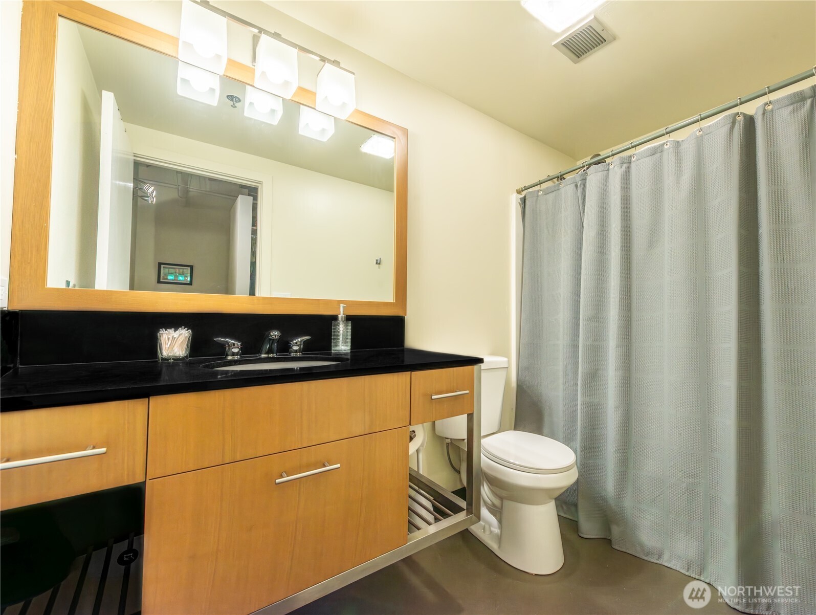 1120 Cliff Street, Unit 211 Tacoma, WA 98402 - Photo 8 of 20 a bathroom with a sink a toilet and a mirror