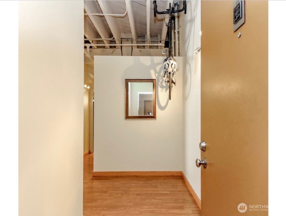 1120 Cliff Street, Unit 211 Tacoma, WA 98402 - Photo 9 of 20 a view of a hallway with wooden floor