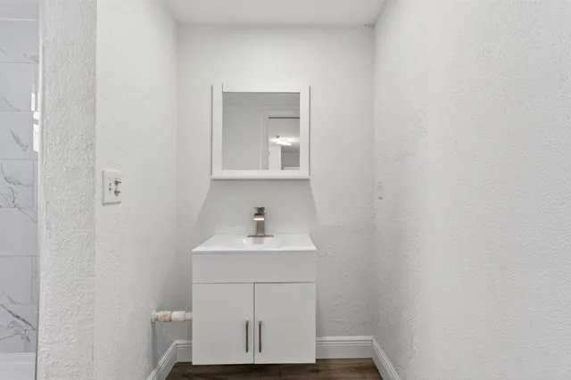 a bathroom with a sink a toilet and mirror