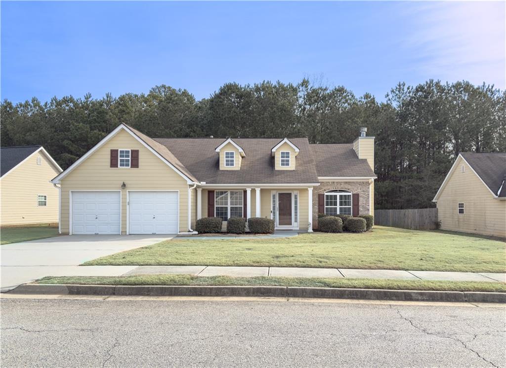 95 Stone Commons Way Covington, GA 30016 - Photo 1 of 1 a view of a big house with a big yard and large trees