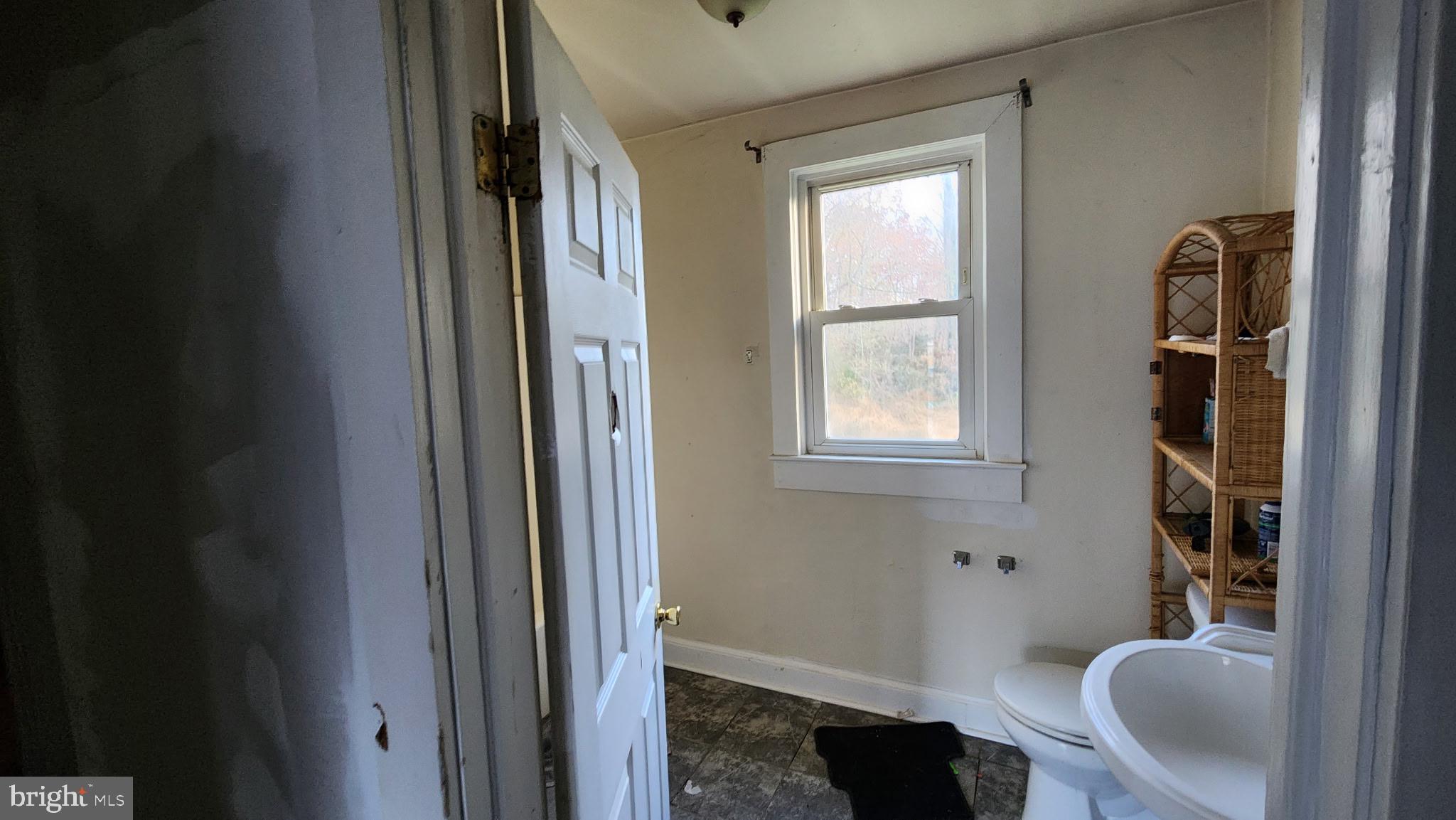 14130 Chotank Loop King George, VA 22485 - Photo 5 of 17 a bathroom with a toilet a sink and a window