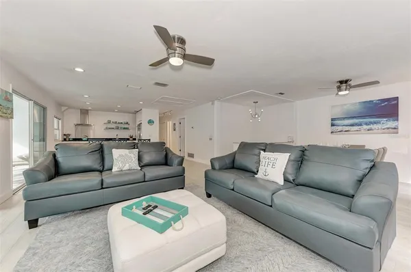 a view of a dining room with furniture and a kitchen