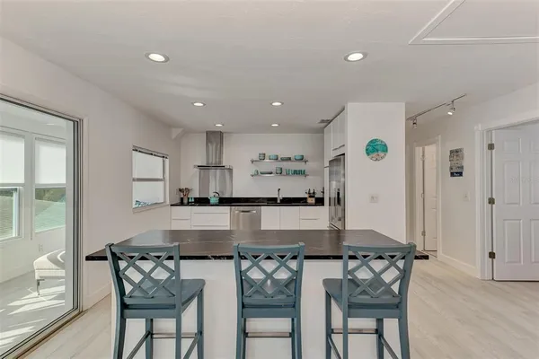 a kitchen with granite countertop a sink and cabinets