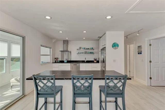 a kitchen with granite countertop a sink and cabinets