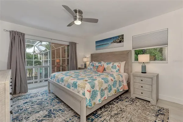 a bedroom with a bed lamp and a window