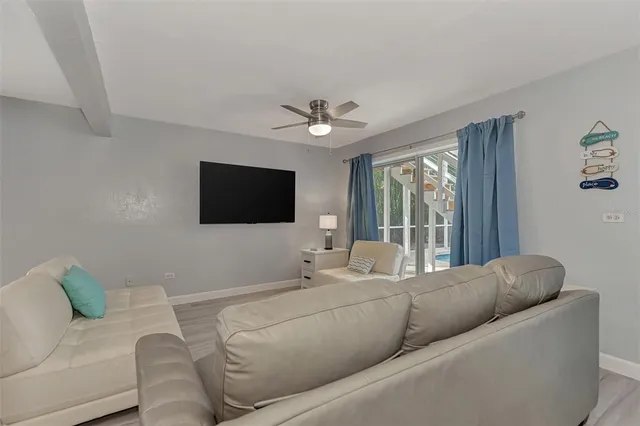 a dining room with furniture and a floor to ceiling window