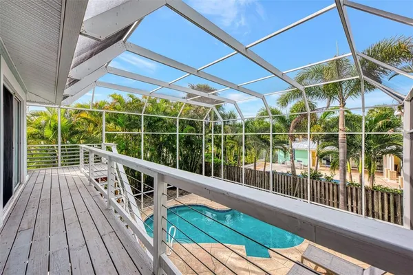 a view of a house with swimming pool and sitting area