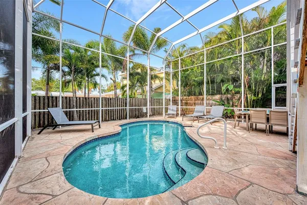 a view of swimming pool with a garden and deck