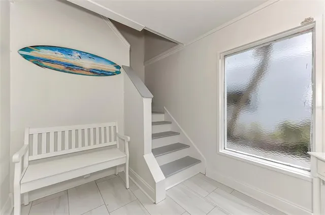 a living room with furniture a flat screen tv and a large window