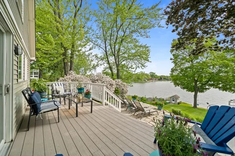 a view of a chairs and table on the wooden deck