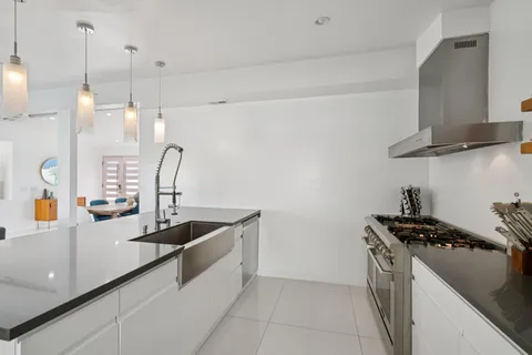 a kitchen that has a sink and a stove