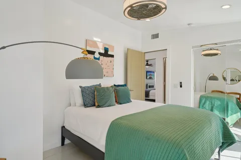 a bedroom with a bed and a chandelier