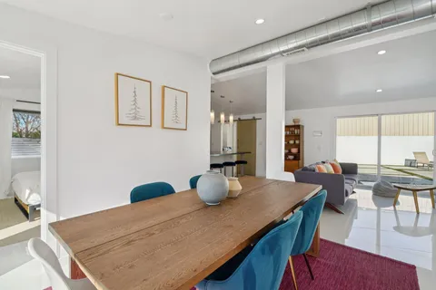 a dining room with furniture and wooden floor