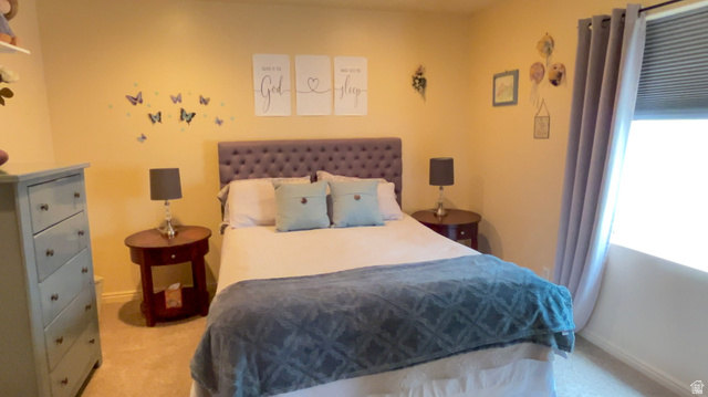 1797 Sunset Road Enoch, UT 84721 - Photo 38 of 80 Bedroom featuring carpet flooring, warm toned walls, a window with blinds, and drapery