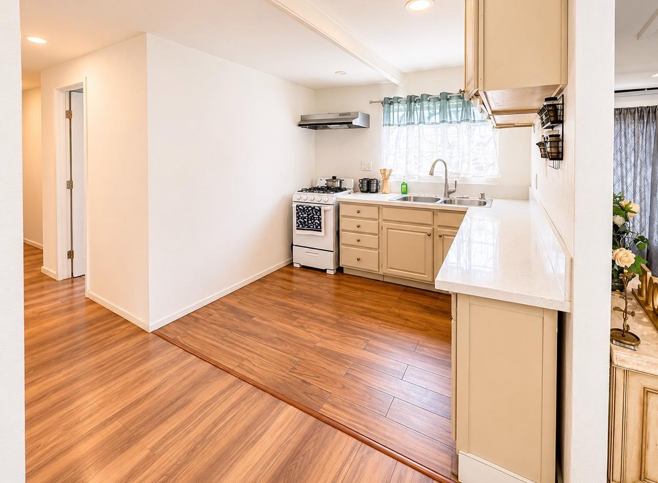 5000 Pierce Road, Unit 32 Bakersfield, CA 93308 - Photo 6 of 15 a kitchen with stainless steel appliances wooden floor and a refrigerator