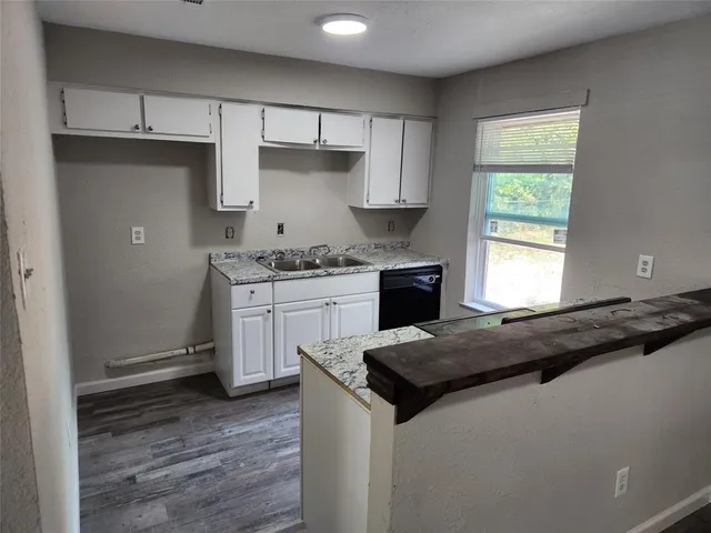 a kitchen with a stove a sink and a refrigerator