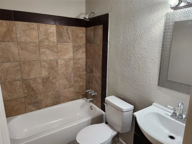 a bathroom with a sink toilet and bathtub