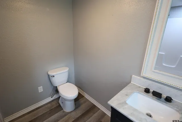a white toilet sitting next to a bathroom sink