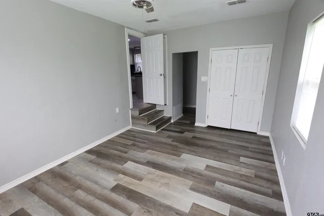 a view of room with window and hardwood floor