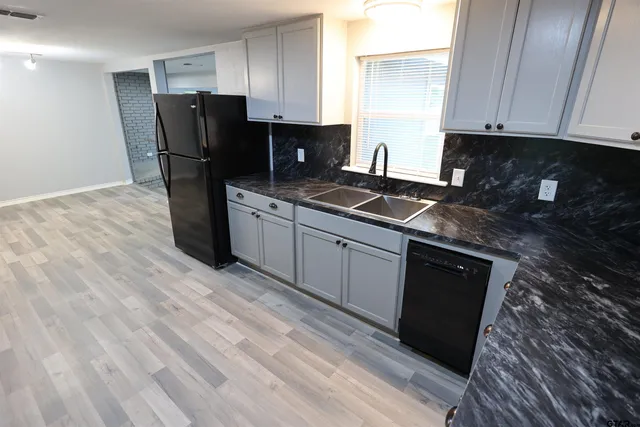 a kitchen with stainless steel appliances granite countertop a refrigerator sink and cabinets