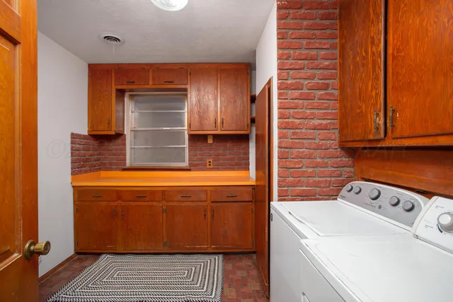 a view of a dining room with furniture a kitchen and chandelier