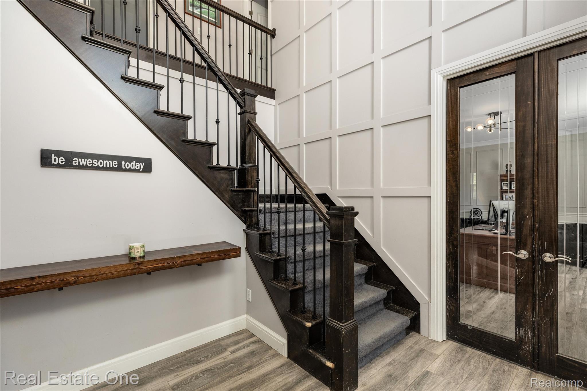 2983 28 Mile Road Washington, MI 48094 - Photo 3 of 54 Grand staircase featuring wood-finish treads, carpeted risers, and wrought iron balusters