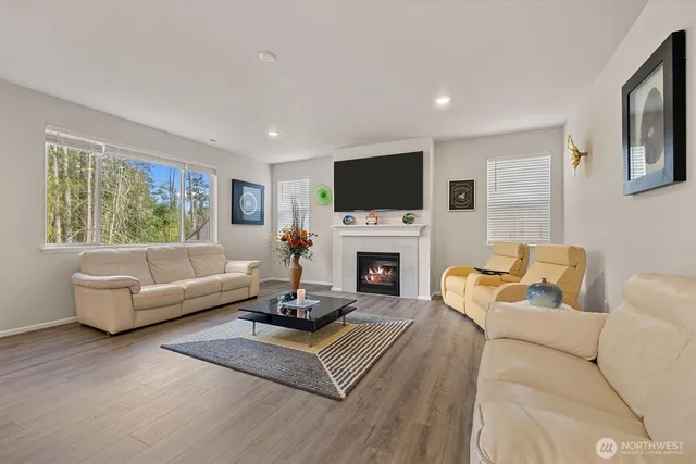 a living room with furniture a fireplace and a flat screen tv