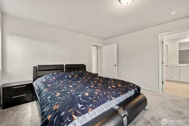 a bedroom with a bed and cabinets