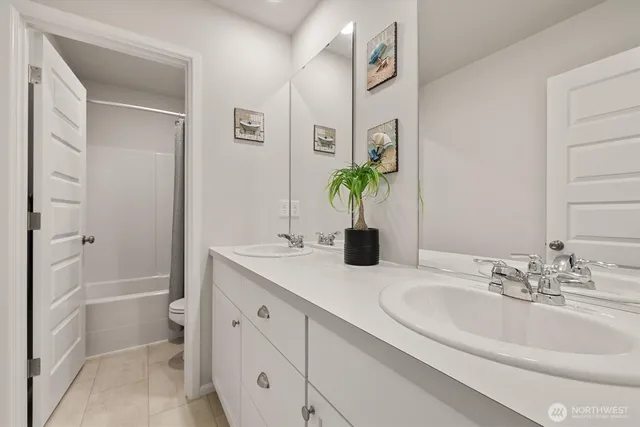 a bathroom with a granite countertop sink a toilet and shower