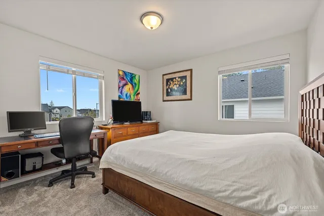 a bedroom with a bed and a desk