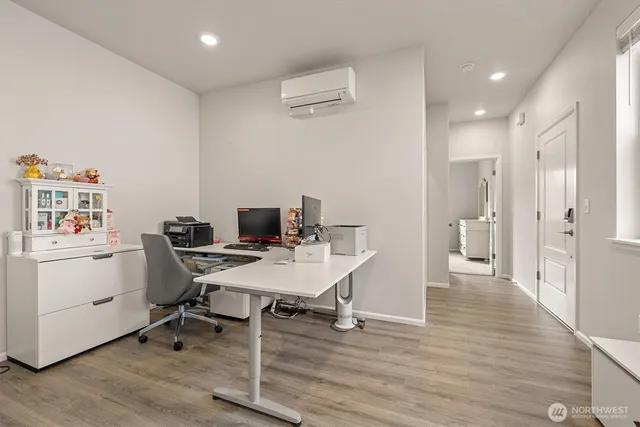 a view of a workspace with furniture and wooden floor