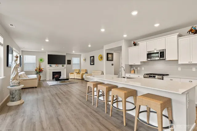 an open kitchen with sink and cabinets