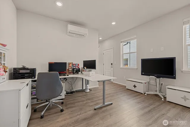 a view of a livingroom with workspace and a window