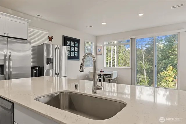 a kitchen with a sink and a large window