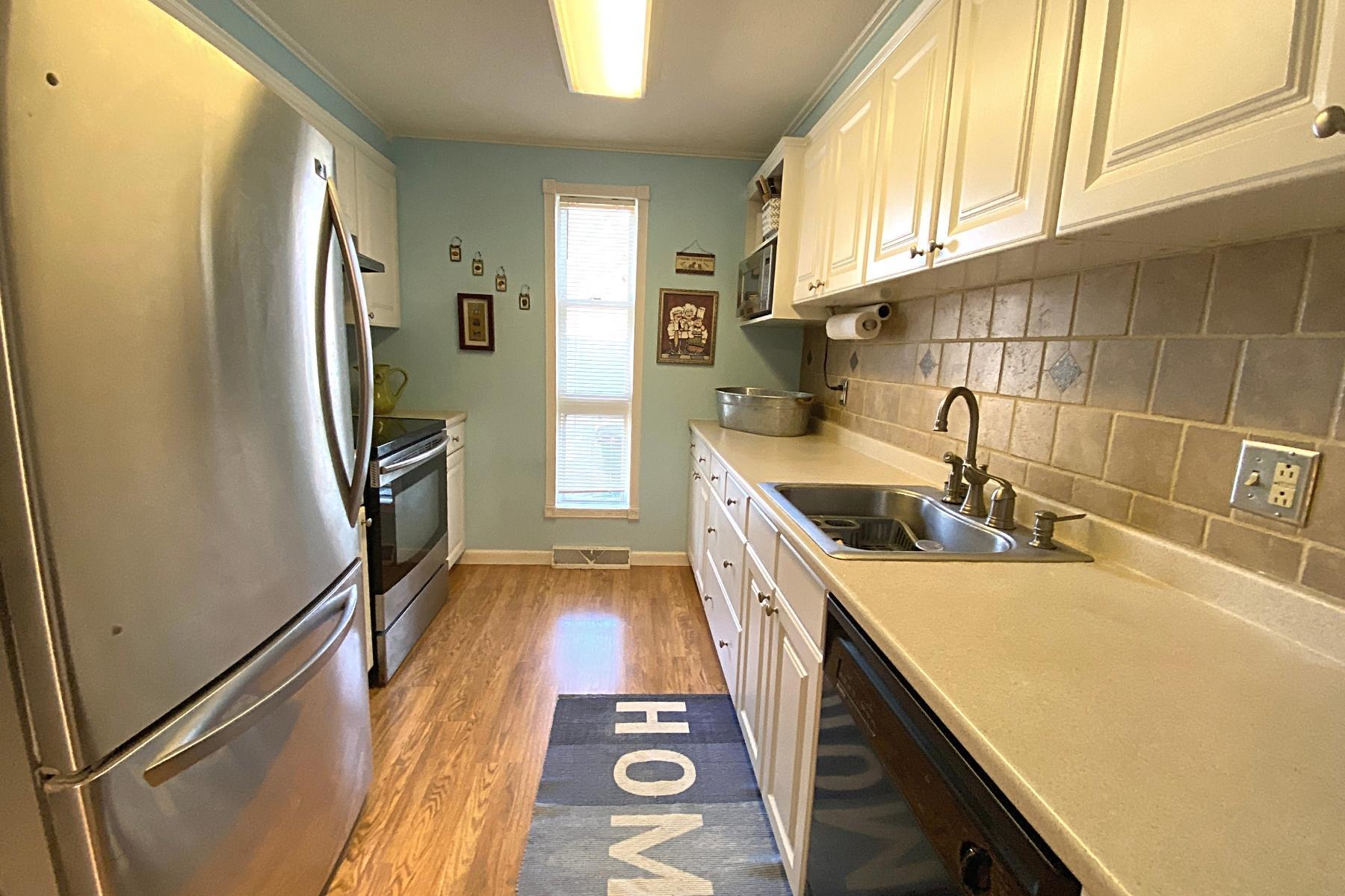 300 Buck Island Road, Unit 7B West Yarmouth, MA 02673 - Photo 11 of 22 a kitchen with stainless steel appliances granite countertop a sink stove and refrigerator