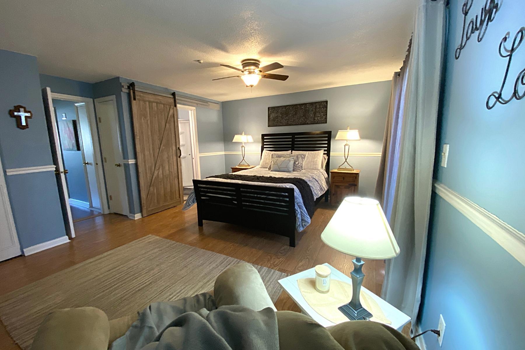 300 Buck Island Road, Unit 7B West Yarmouth, MA 02673 - Photo 12 of 22 a bedroom with a bed and a chandelier